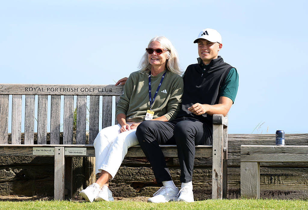 Ludvig Aberg and his mum pose for a photo on the bench at the 6th tee at Royal Portrush